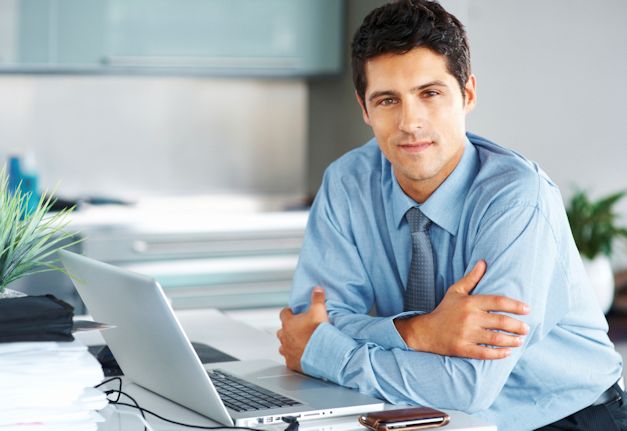 This interviewer is sitting at a desk with a open laptop prepared for the next interview