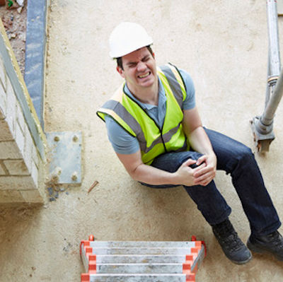 Worker who has fallen in pain holding knee