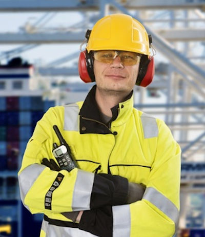 Worker in full PPE standing looking forward