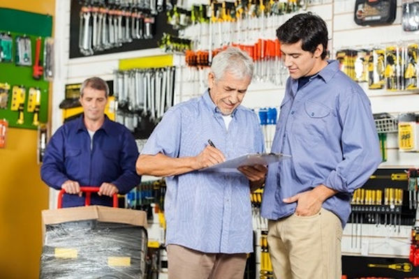 Employee working and two others conducting an inspection