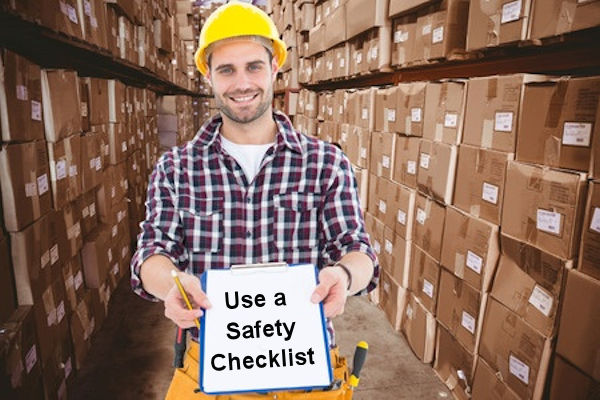 Happy employee holding a safety checklist