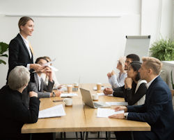 Leader presenting to a group in a meeting