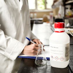 Lab worker checking chemical container