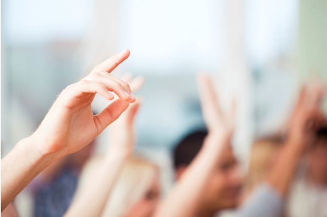 image of students raising hands