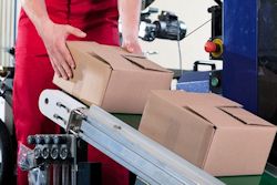 Employee receiving boxes off a conveyor belt to demonstrate tasks for a job hazard analysis