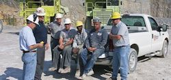 safety meeting outside with workers around pick up truck