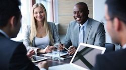 managers and employees meeting around a table