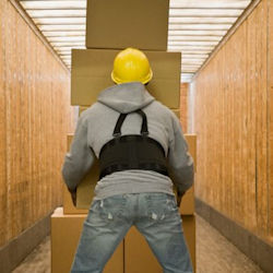 Worker wearing a backbelt to lift boxes