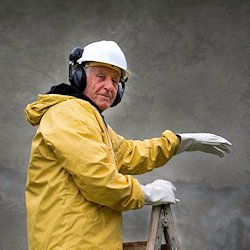 Older worker standing on ladder.