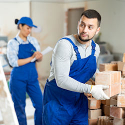 Workers lifting bricks