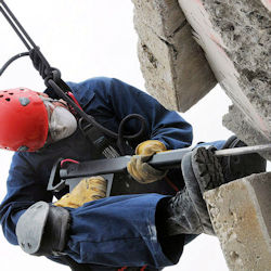 Worker using a vibrating tool requiring a strong grip.