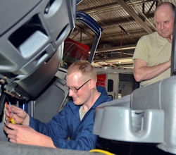 Instructor watching employee as part of the on the job training.