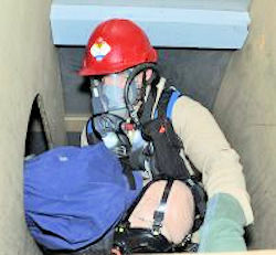 Worker training for confined space rescue using a dummy.