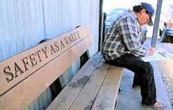 Man sitting on bench that says safety as a value