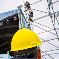 supervisor inspecting workers installing scaffold