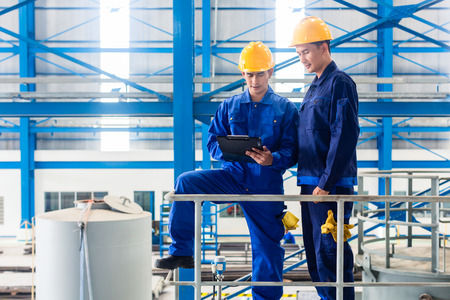 two workers inspecting a warehouse