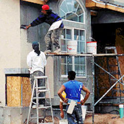 workers plastering house