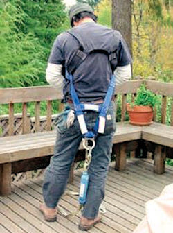 worker putting harness on