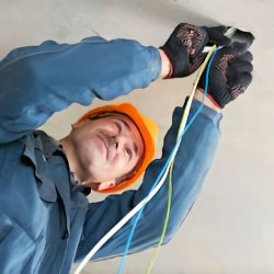 Electrician working on ceiling outlet