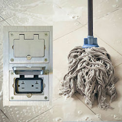 Wet mop too close to plug located in floor.