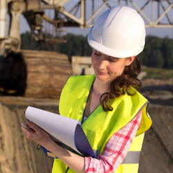 Worker conducting an inspection and taking notes.