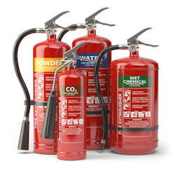 Group of four various styles of fire extinguishers 