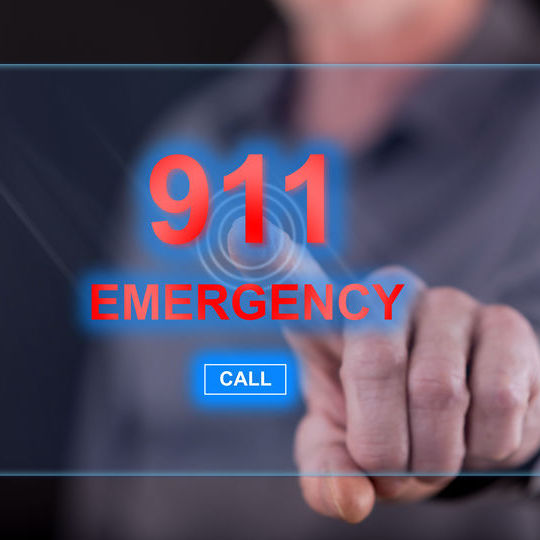 Poster showing call 911 for emergencies.