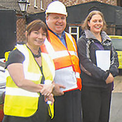 Three evacuation coordinators standing together.