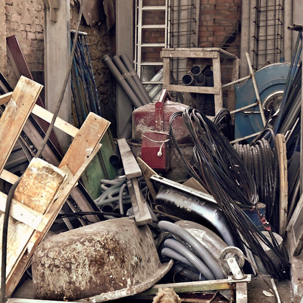 Dangerous cluttered storage area possibly containing combustible materials.