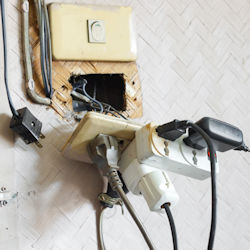 Damaged overloaded electrical sockets