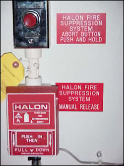 Halon alarm system mounted on wall.