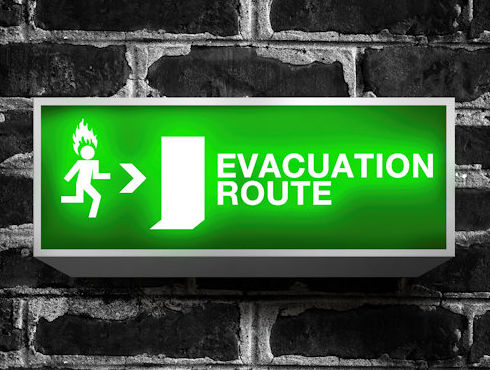 Bright green and white sign showing Evacuation Route