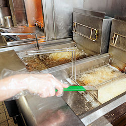 Restaurant kitchen with two grease fryers.