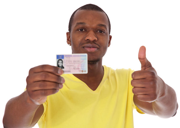 Person holding up license giving a thumbs up.