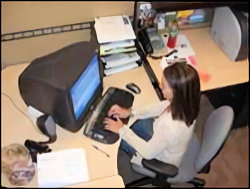 Image of female working at a computer station