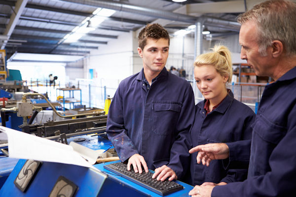 Image of three workers discussing a training strategy