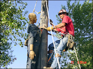 Image of worker conducting rescue on the job training with a dummy.