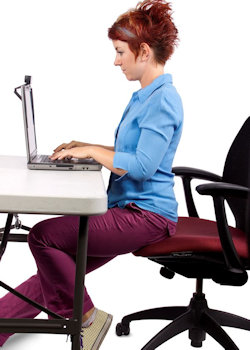 employee sitting with poor posture at computer station