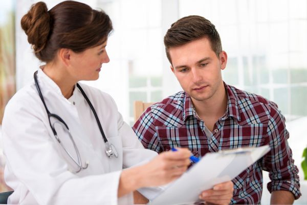 Image showing doctor reviewing medical records with an employee