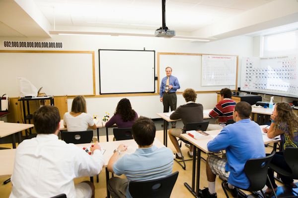 Image of trainer illustrating skills while giving a presentation in classroom training session