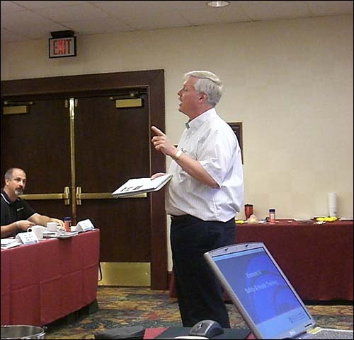 Image of students asking questions during a training presentation