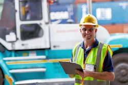  worker inspecting a forklift