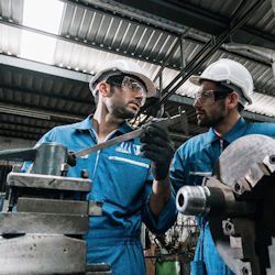 Image showing worker with gloves working with a lathe