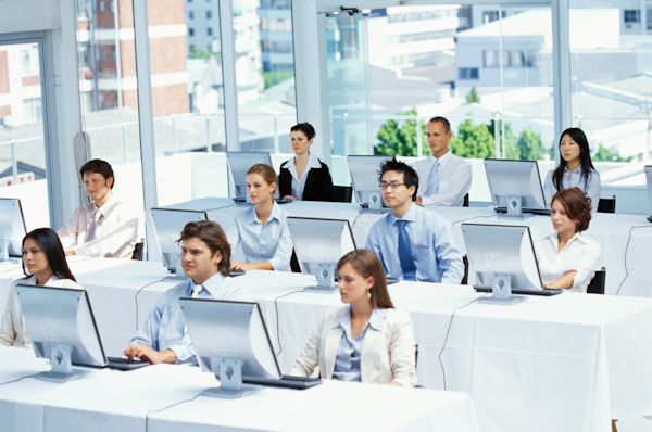 employee training in classroom sitting with computers