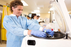 Lab worker operating a centrifuge