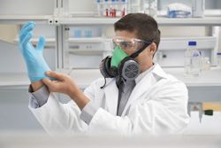  Lab worker with eye and face and hand protection