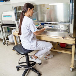 lab worker working behind barrier