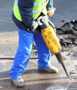 Image of worker using jack hammer.