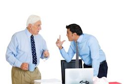 Image of two managers arguing at desk.