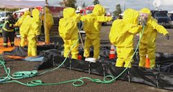 Image of employees moving through a decontamination station.